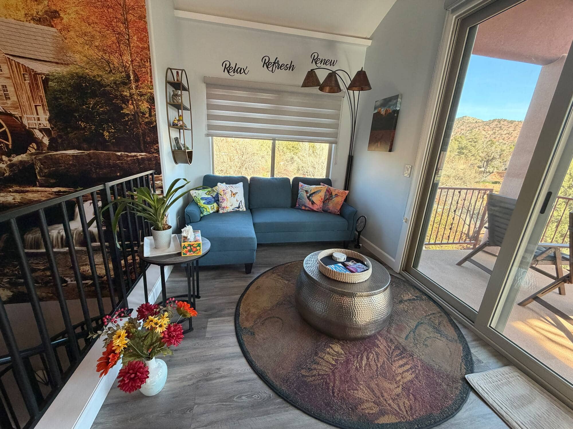 A bright casita living room with a red-rock view through the patio door