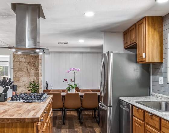 A kitchen island and range wiped down and reset